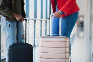 Two african girls with suitcases at the airport. The concept of travel and vacation. photo