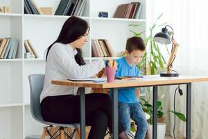 Child psychologist working with boy in office photo
