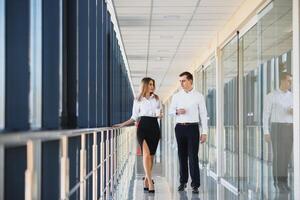 The business people walk in the office hall photo