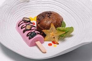 Chocolate fondant with vanilla ice cream and raspberry sauce photo