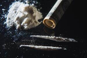 Hard drugs on black table. Close up photo