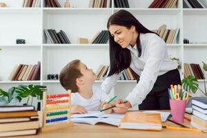 Portrait of pretty tutor and diligent pupil looking at each other while communicating photo