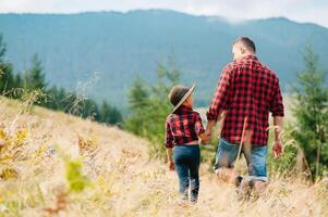 Happy father and little child are walking in the mountains. Father's Day. vacation in the national park photo