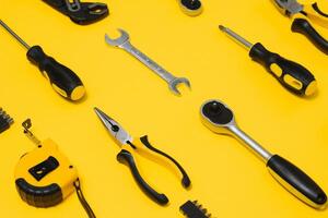 Set of various construction tools. Tools for home repair. Work at a construction site. On a yellow background. Flatly. Flatlay photo