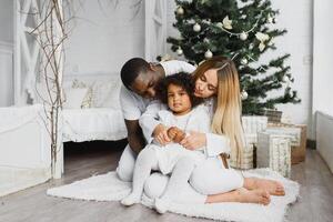 happy multiracial family with gifts at Christmas photo