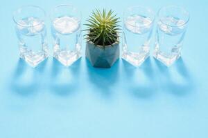 Glasses of water on a paper background. Drawing shadows. Classic Blue color. clean water concept photo