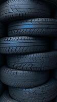 AI generated Stack of car tires with black rubber tread, textured background Vertical Mobile Wallpaper photo