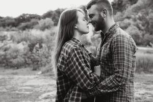 Couple in love rest on green hill in country side photo