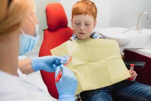 Female dentist and child in a dentist office photo