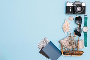 Travel accessories on blue background, travel concept. Top view with copy space photo