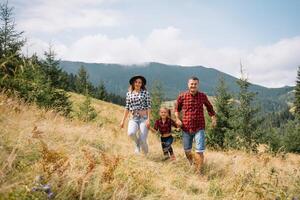 Father and child hiking in scenic mountains. Dad and son enjoying the view from the mountain top in Carpathian mountains. photo