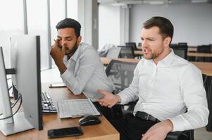 Two diverse crypto traders brokers stock exchange market investors discussing trading charts research reports growth using pc computer looking at screen analyzing invest strategy, financial risks. photo