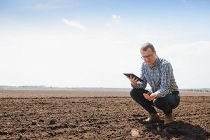 eco-activist at the landfill of used car tires calculates environmental damage. Nature conservation concept photo