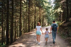 Young family with child resting on a forest photo