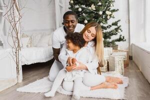 happy multiracial family with gifts at Christmas photo