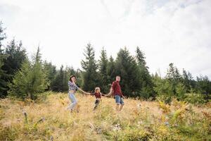 Father and child hiking in scenic mountains. Dad and son enjoying the view from the mountain top in Carpathian mountains. photo