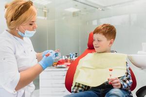 Boy satisfied with the service in the dental office. concept of pediatric dental treatment photo