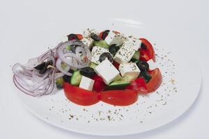 Fresh salad with vegetables and cheese on a white background photo