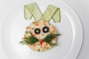 baby salad laid out in the form of a bunny on the plate photo