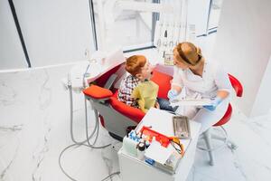 Female dentist and child in a dentist office photo