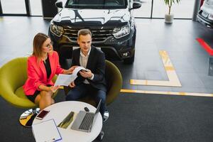 business woman buys a car at a car dealership. Concept of happy business people photo