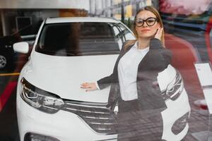 business woman buys a car at a car dealership photo