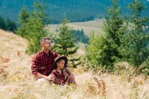 Happy father and little child are walking in the mountains. Father's Day. vacation in the national park photo