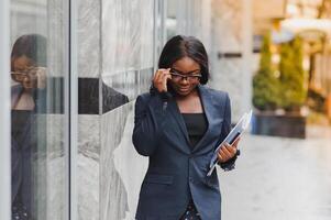 portrait of young african businesswoman standing outdoors photo