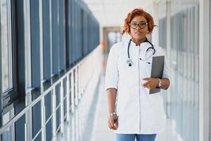 portrait of pretty african medical doctor. african american doctor in modern clinic photo