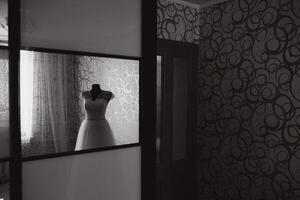 Elegant white wedding dress in the middle of the room. photo