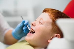 Female dentist and child in a dentist office photo