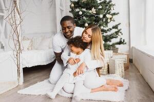 happy multiracial family with gifts at Christmas photo