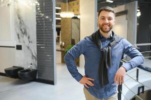 Male customer looking at toilets on sale at a modern store or shopping centre photo