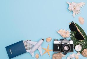 Preparation for Traveling concept, watch, airplane, money, passport, pencils, book, Photo frame, eyeglass on blue background with copy space.