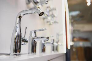 Water faucet, bathroom faucet and kitchen faucet. Chrome-plated metal. photo
