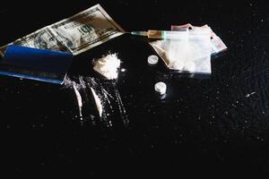 Purchase, possession and sale of drugs is punishable by law. Many types of narcotics and drugs represented on table photo