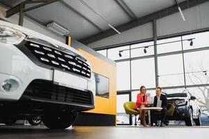 Woman buying the car and seller selling photo