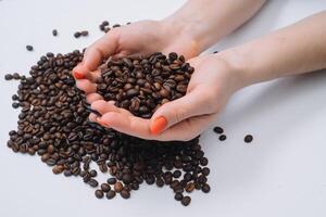 Coffee beans in woman's hands. photo