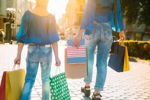 venta, consumismo, dinero y personas concepto - contento joven mujer con compras pantalones y crédito tarjeta en centro comercial foto