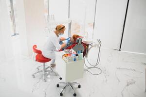 Female dentist and child in a dentist office photo