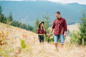 Happy father and little child are walking in the mountains. Father's Day. vacation in the national park photo