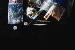 Hard drugs on dark table. photo