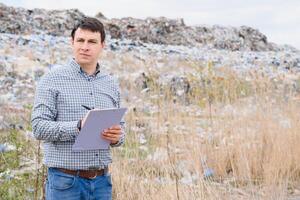 garbage recycling concept. man on dumpster. Keeping the environment clean. Ecological problems. photo