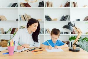 Picture of child psychologist working with young boy in office photo