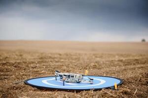 Portable quadcopter against a blue sky with white Cirrus clouds. photo