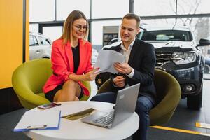 business woman buys a car at a car dealership. Concept of happy business people photo