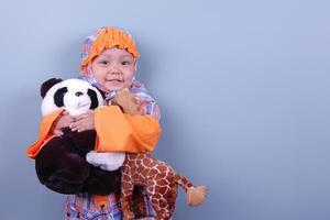 An Indonesian little girl wearing hijab cloth while holding her lovely doll photo