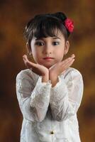 A Young Asian girl wearing Javanese Traditional Clothes photo