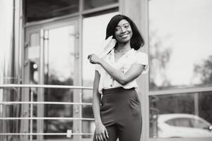 African american young volunteer woman wearing face mask outdoors. Coronavirus quarantine and global pandemic. photo