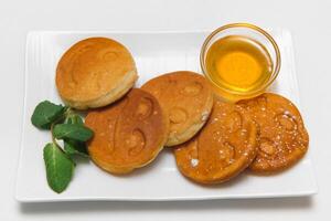 children's menu. pancakes with honey photo